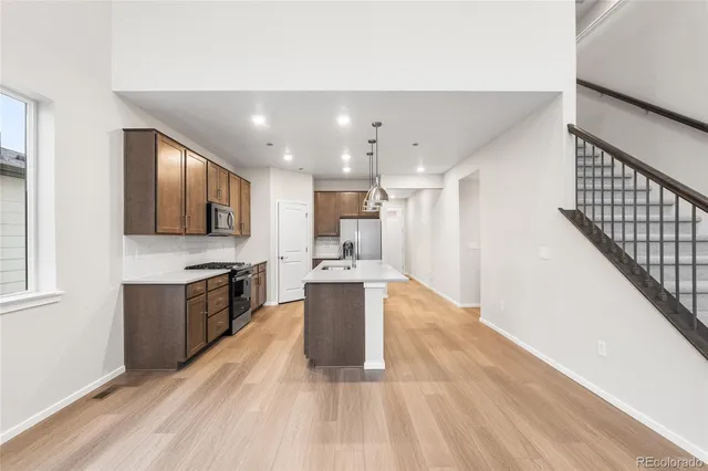 a large kitchen with a large counter top appliances and cabinets