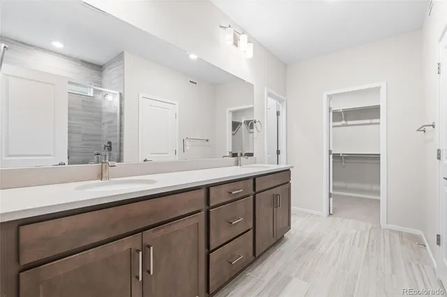 a spacious bathroom with a double vanity sink double and mirror