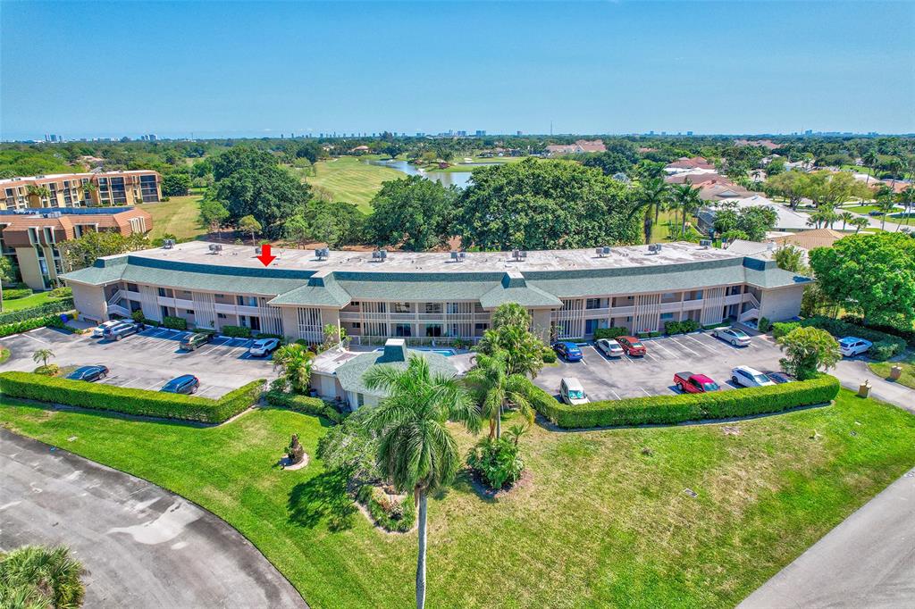 a front view of a house with a garden and trees