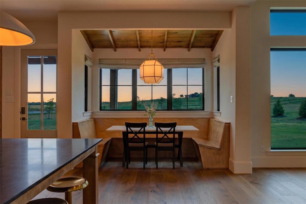 10932 Gregory Road Sanger, TX 76266 - Photo 9 of 40 Built-in dining nook with wood-finish flooring, black-framed windows, and a coffered wood ceiling