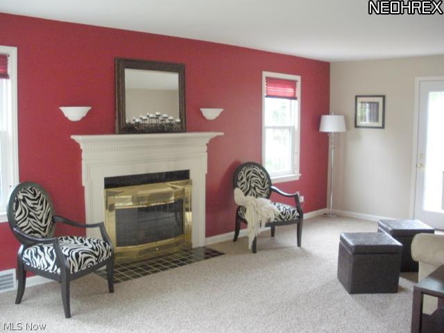 1144 Garman Road Akron, OH 44313 - Photo 4 of 22 The livng room located to the left of the foyer features neutral decor, gas log fireplace with pretty white mantle, pretty windows allow for natural lighting, door to deck.
