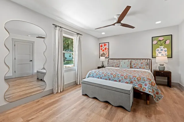 a bathroom with a sink toilet mirror and shower