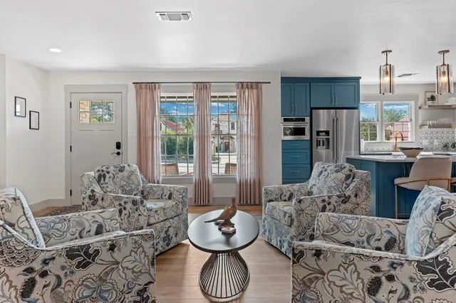 a living room with furniture and large windows