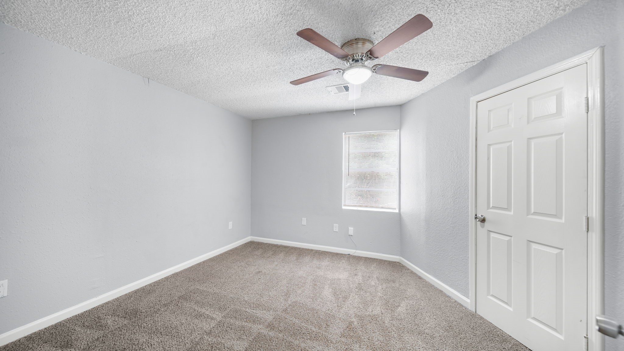 2363 Virginia Avenue Montgomery, TX 77316 - Photo 11 of 19 an empty room with windows and fan