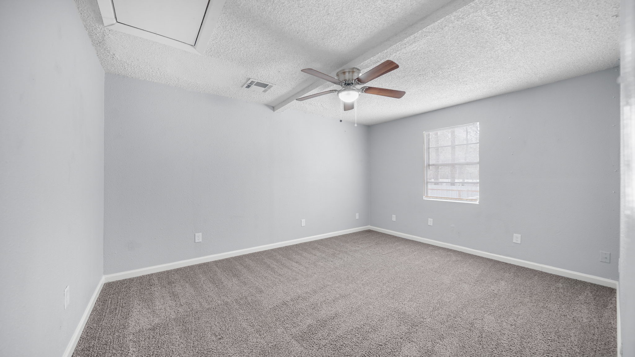 2363 Virginia Avenue Montgomery, TX 77316 - Photo 15 of 19 an empty room with windows and fan