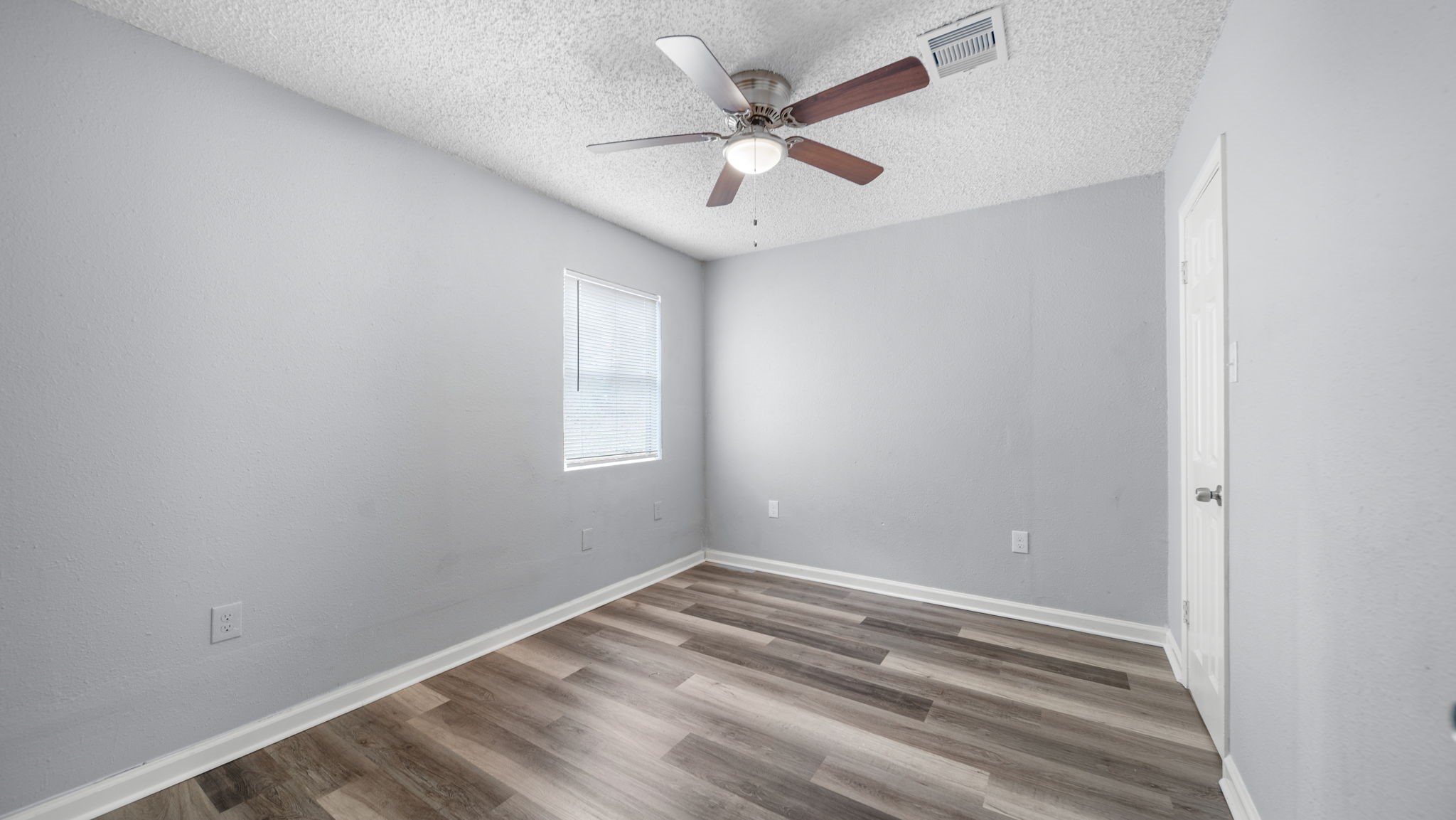 2363 Virginia Avenue Montgomery, TX 77316 - Photo 16 of 19 an empty room with a window and a fan