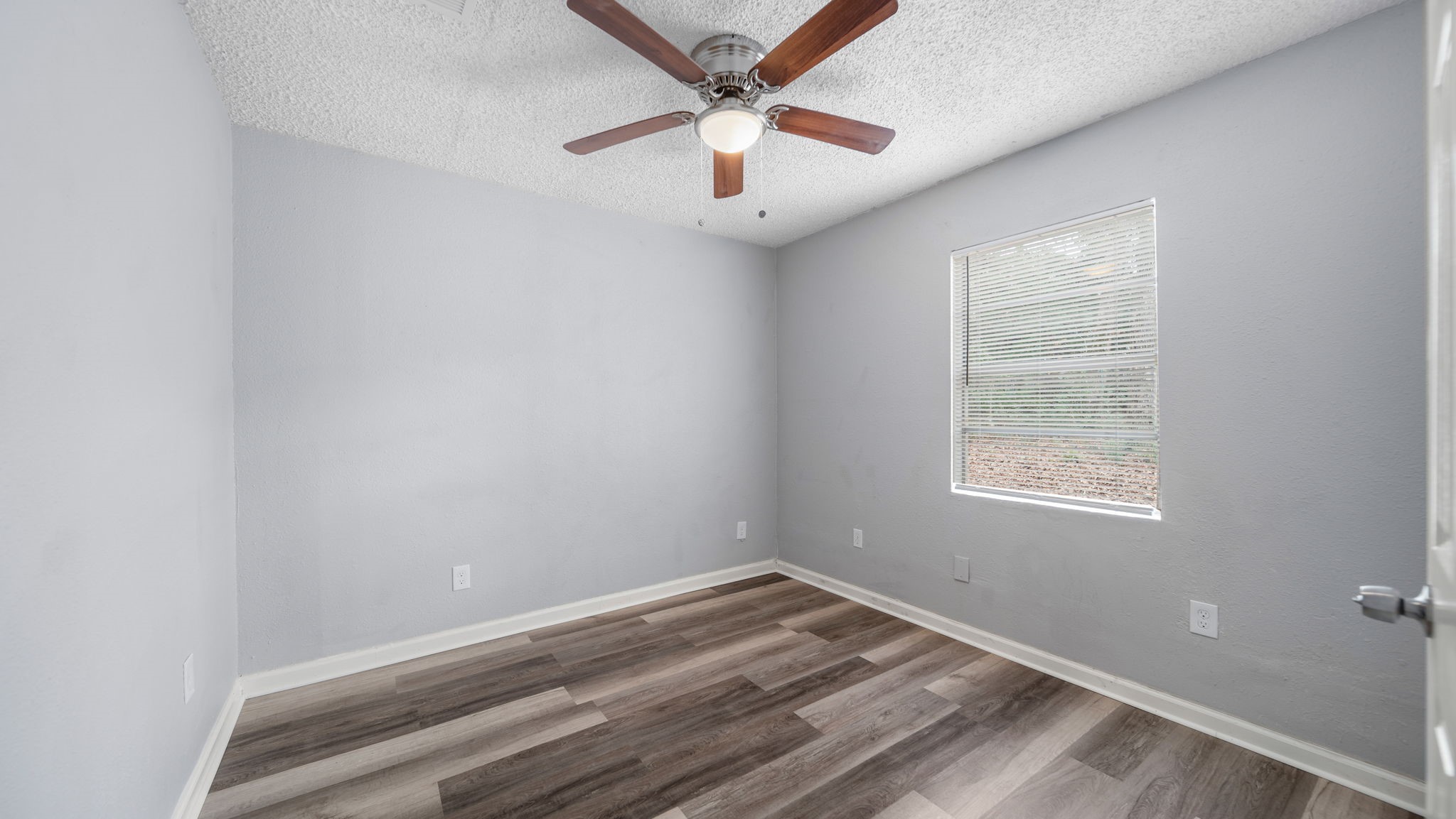 2363 Virginia Avenue Montgomery, TX 77316 - Photo 17 of 19 an empty room with a window and a ceiling fan