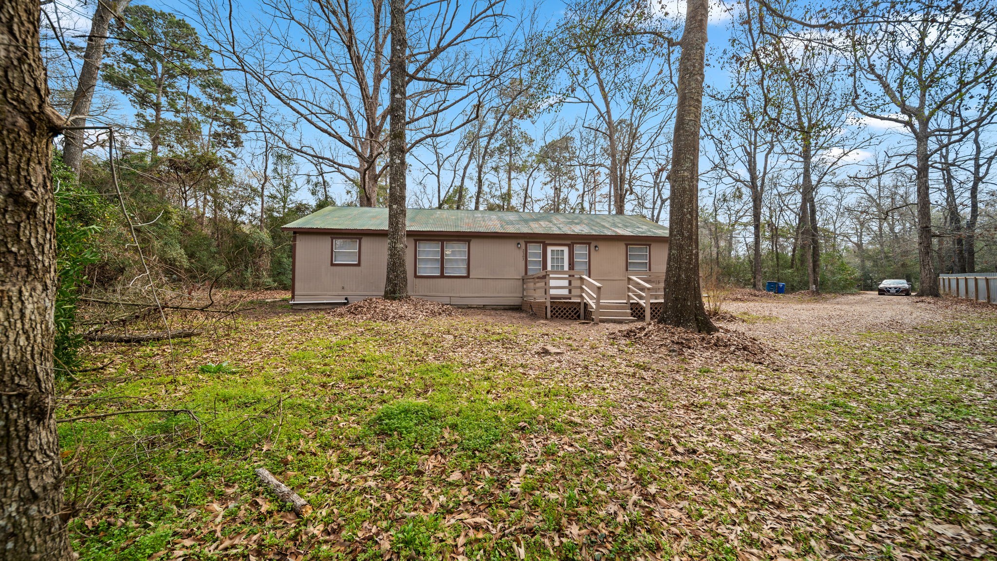 2363 Virginia Avenue Montgomery, TX 77316 - Photo 2 of 19 a view of a house with a yard covered with snow and trees