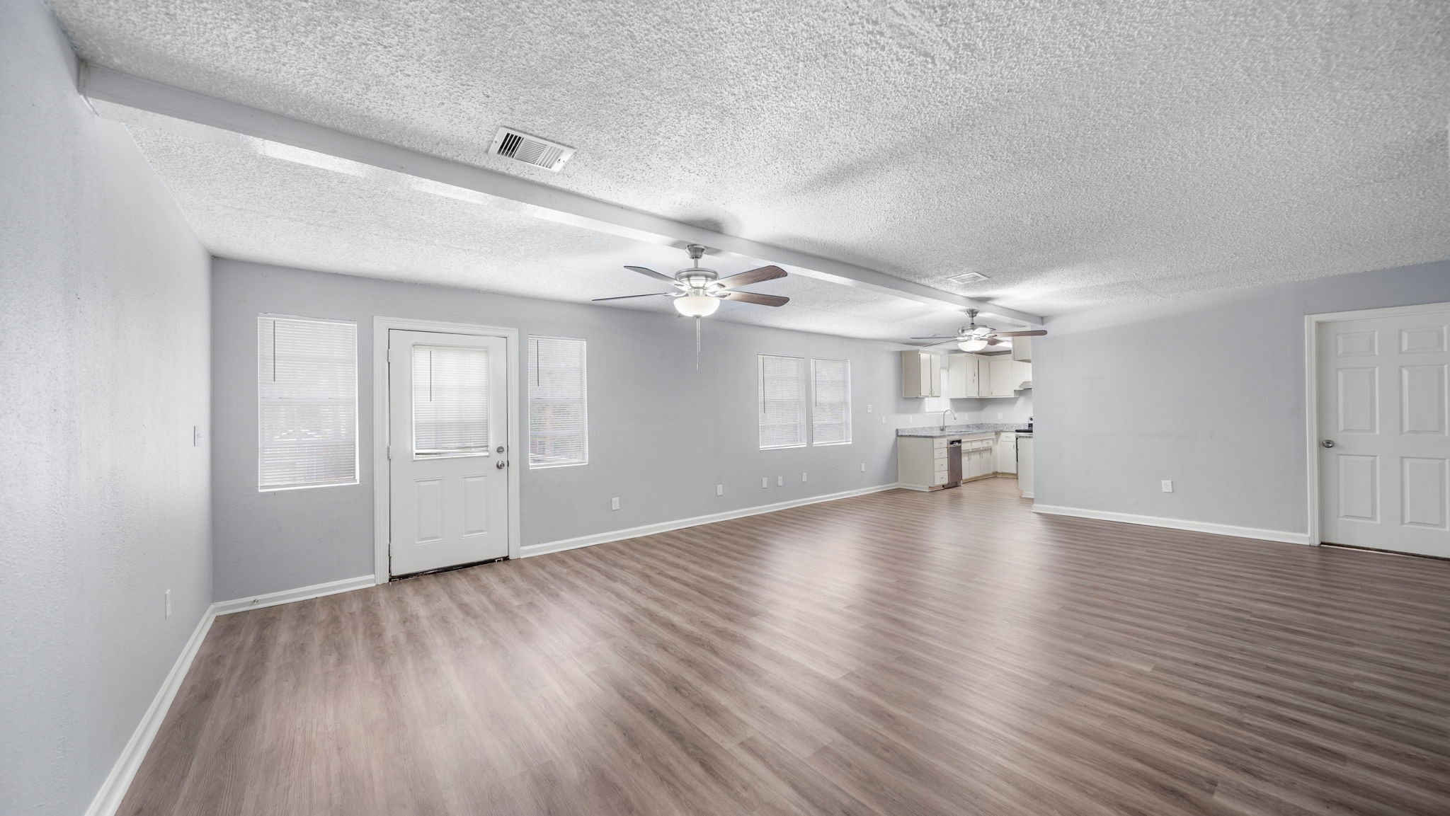 2363 Virginia Avenue Montgomery, TX 77316 - Photo 7 of 19 wooden floor in an empty room with a window