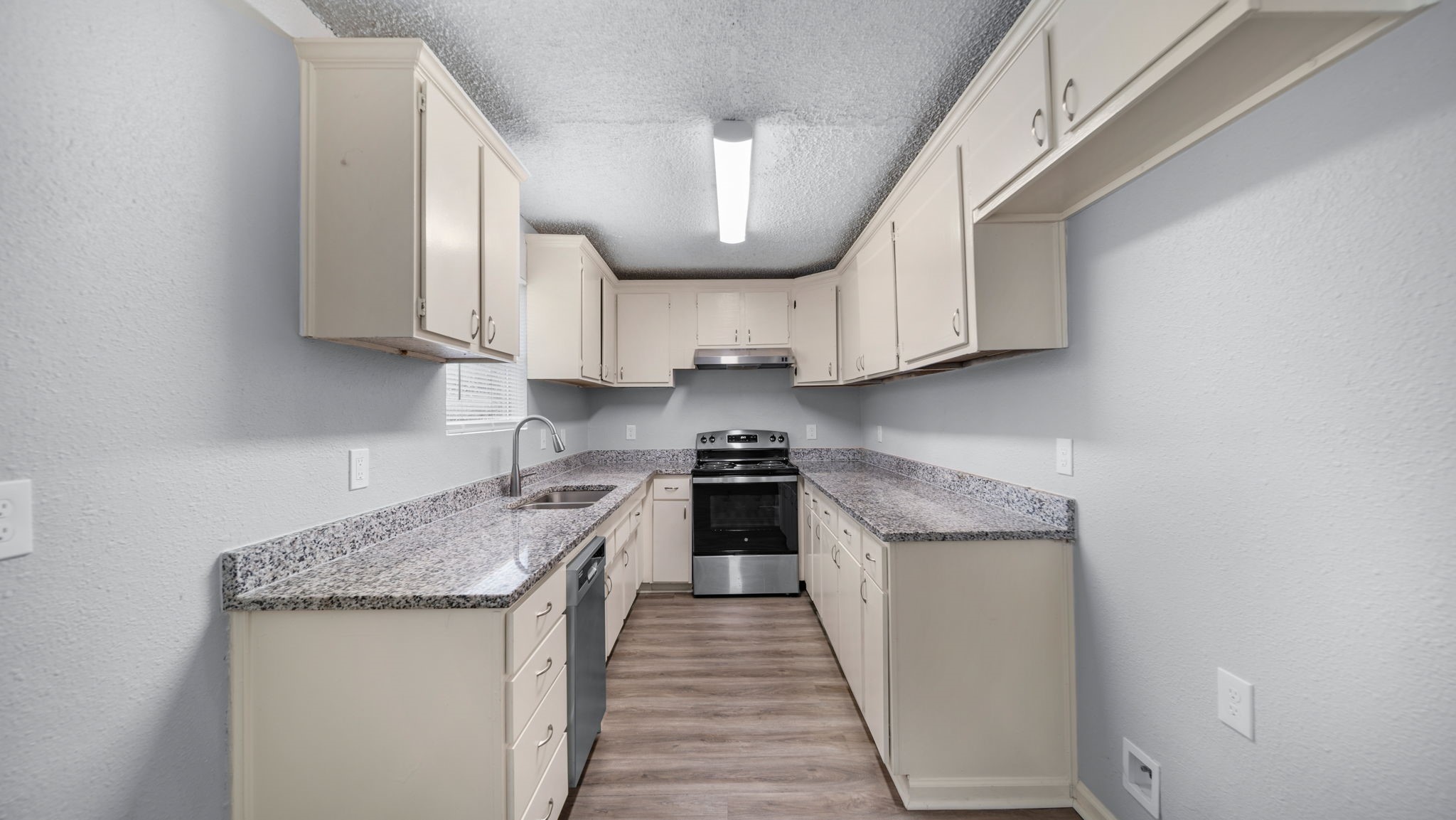 2363 Virginia Avenue Montgomery, TX 77316 - Photo 9 of 19 a kitchen with stainless steel appliances granite countertop a sink stove and cabinets