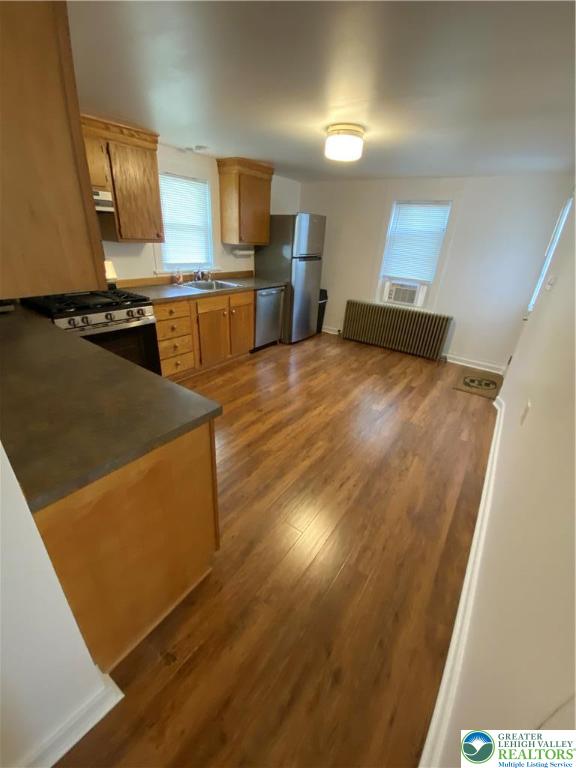 16 South 3rd Street, Unit 1 Emmaus, PA 18049 - Photo 10 of 12 a kitchen with stainless steel appliances a stove a refrigerator a sink a counter top space and cabinets