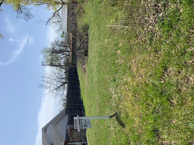 a view of house with backyard