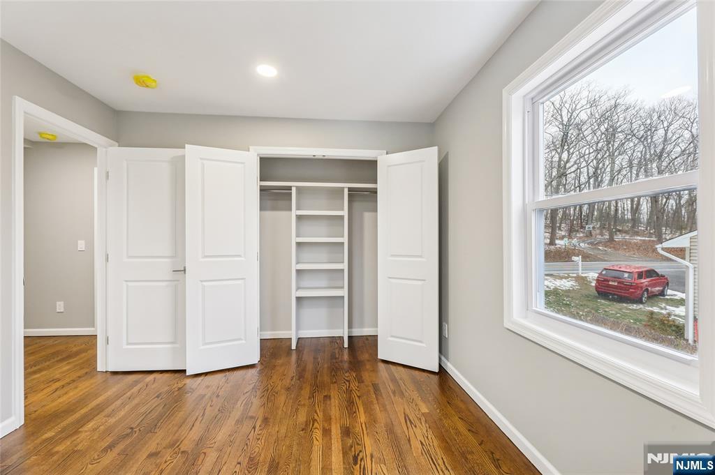 448 Morsetown Road West Milford, NJ 07480 - Photo 14 of 27 a view of empty room with wooden floor and fan