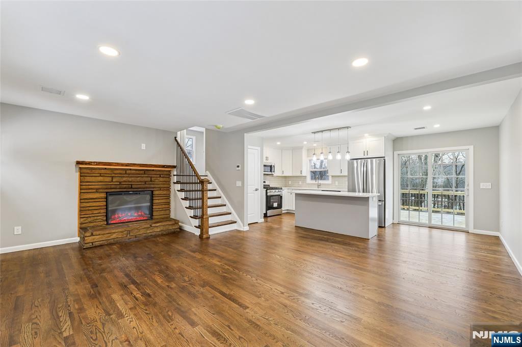 448 Morsetown Road West Milford, NJ 07480 - Photo 3 of 27 a view of an empty room with wooden floor fireplace and a window