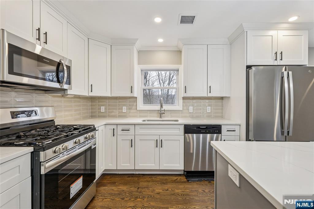 448 Morsetown Road West Milford, NJ 07480 - Photo 7 of 27 a kitchen with stainless steel appliances granite countertop a stove top oven a sink and a refrigerator