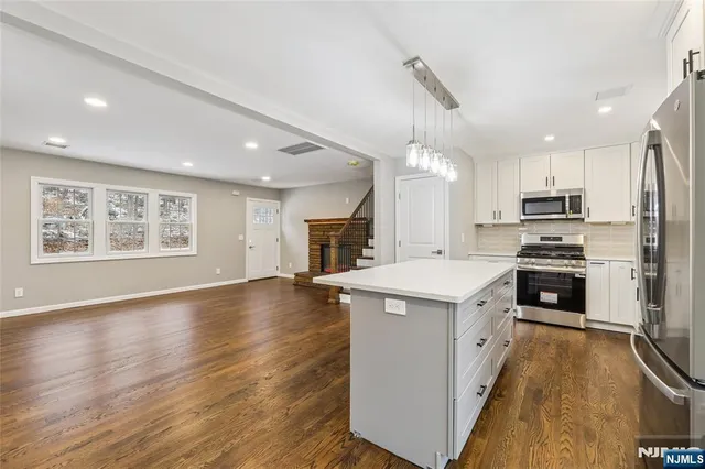 a kitchen with a stove a sink and a refrigerator