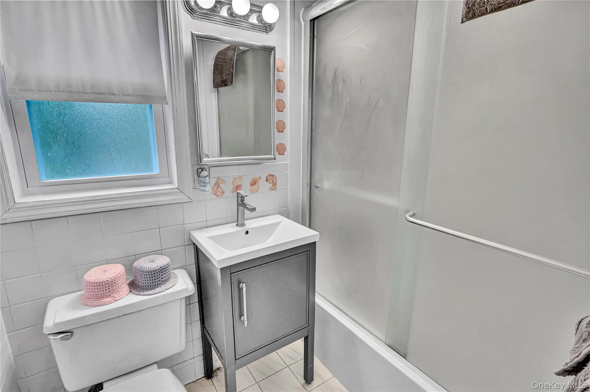 20 Toehee Place, Unit 2B Islip, NY 11751 - Photo 11 of 25 a bathroom with a sink toilet and mirror