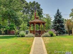 20 Toehee Place, Unit 2B Islip, NY 11751 - Photo 16 of 25 a view of a backyard with a garden