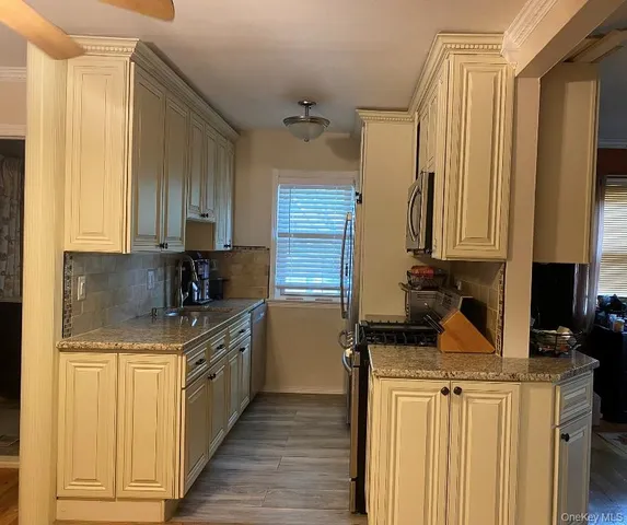 a kitchen with a sink stove and cabinets