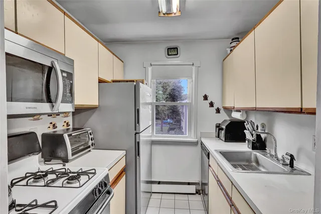 a kitchen with a sink stove and refrigerator