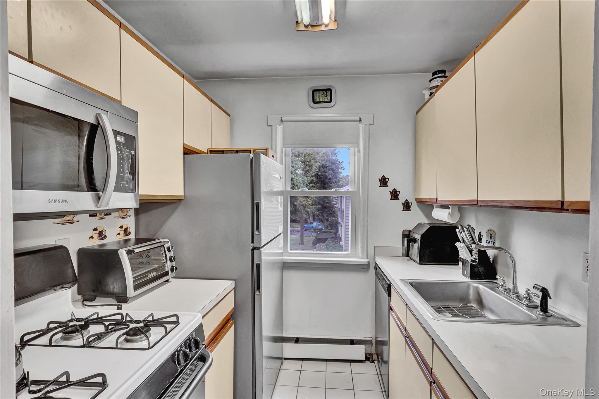 20 Toehee Place, Unit 2B Islip, NY 11751 - Photo 9 of 25 a kitchen with a sink stove and refrigerator