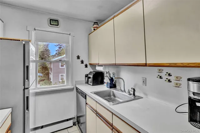 a kitchen with appliances cabinets and a window