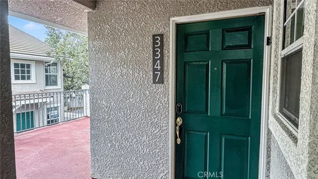 front view of a house with a green door and a yard