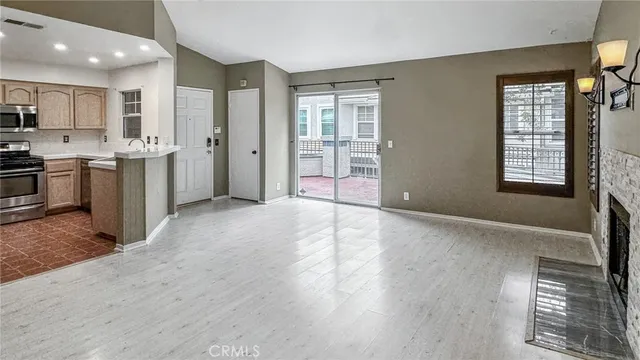 a view of a kitchen with a sink dishwasher and fireplace