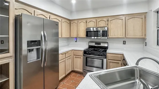 a kitchen with a refrigerator stove and sink