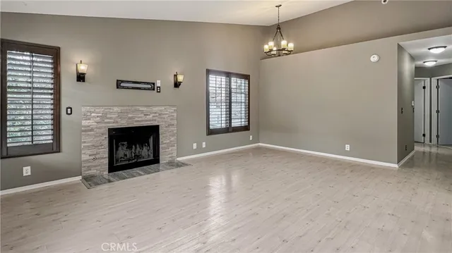 a view of a livingroom with a fireplace and window