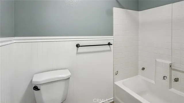 a bathroom with a bathtub and toilet