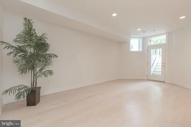 an empty room with window and outdoor view