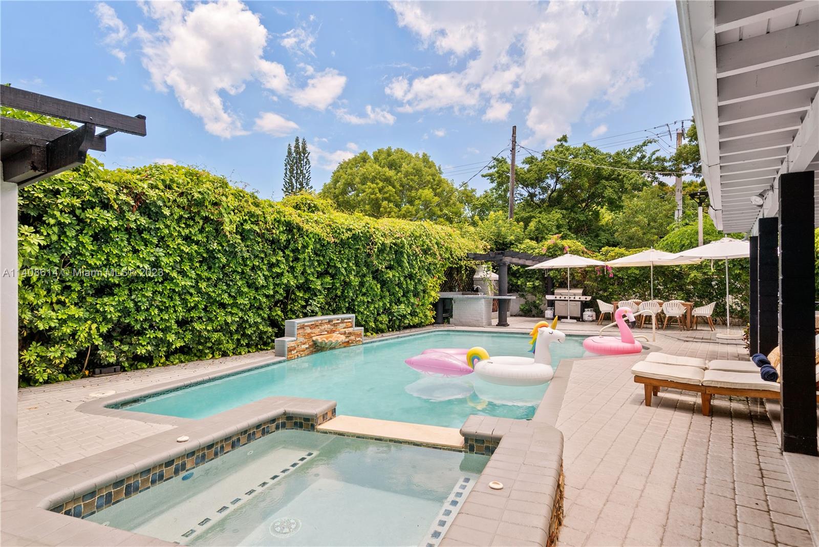 a view of a patio with swimming pool and sitting area