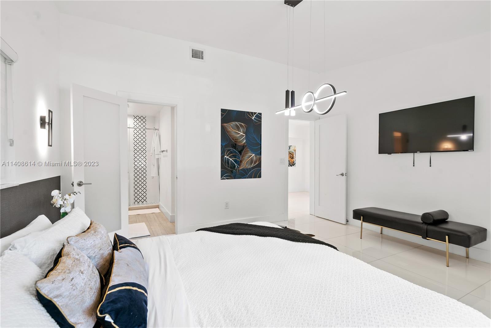 401 Southwest 23rd Road Miami, FL 33129 - Photo 11 of 43 a bedroom with a bed and a flat screen tv