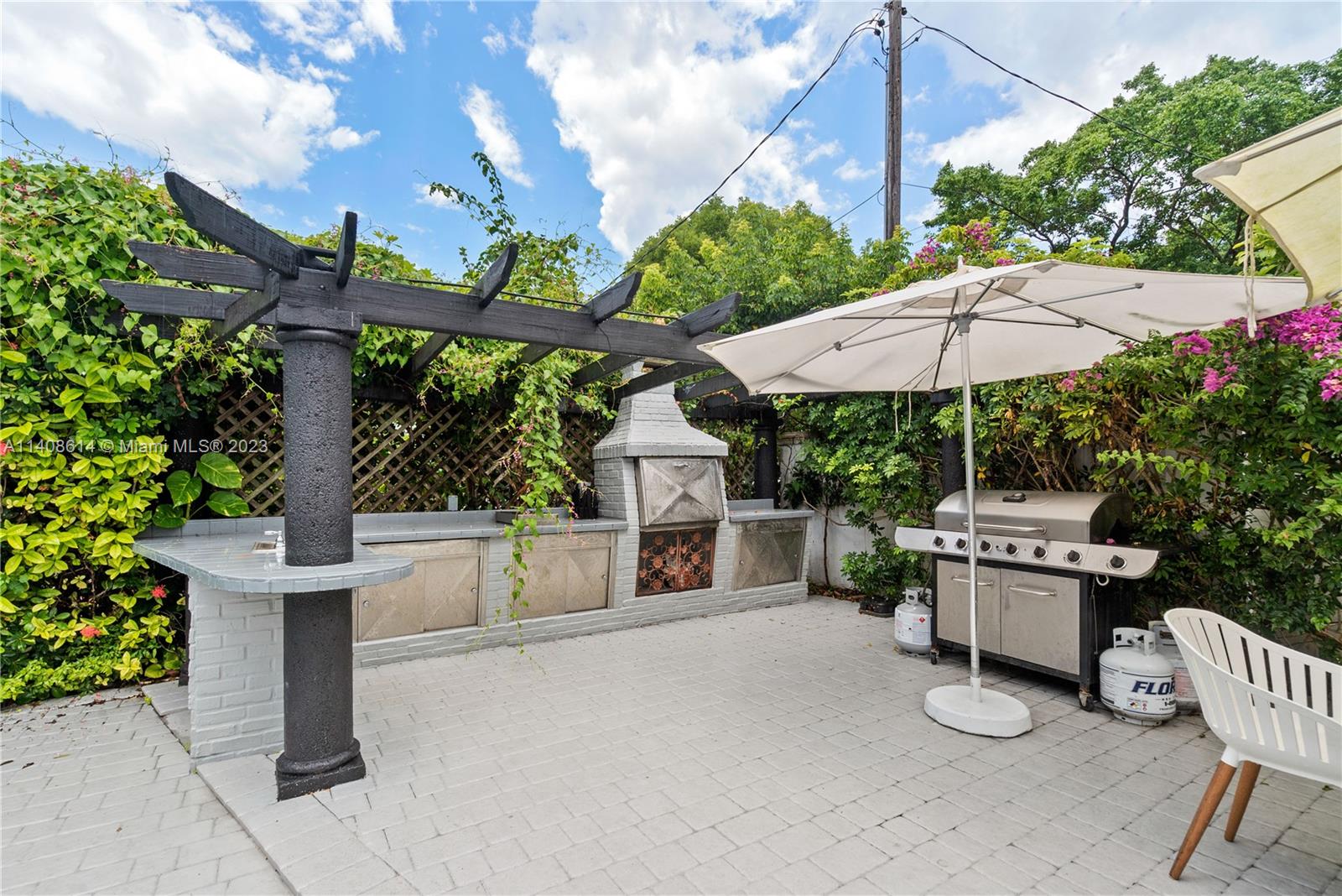 401 Southwest 23rd Road Miami, FL 33129 - Photo 15 of 43 a view of a patio with a table and chairs under an umbrella
