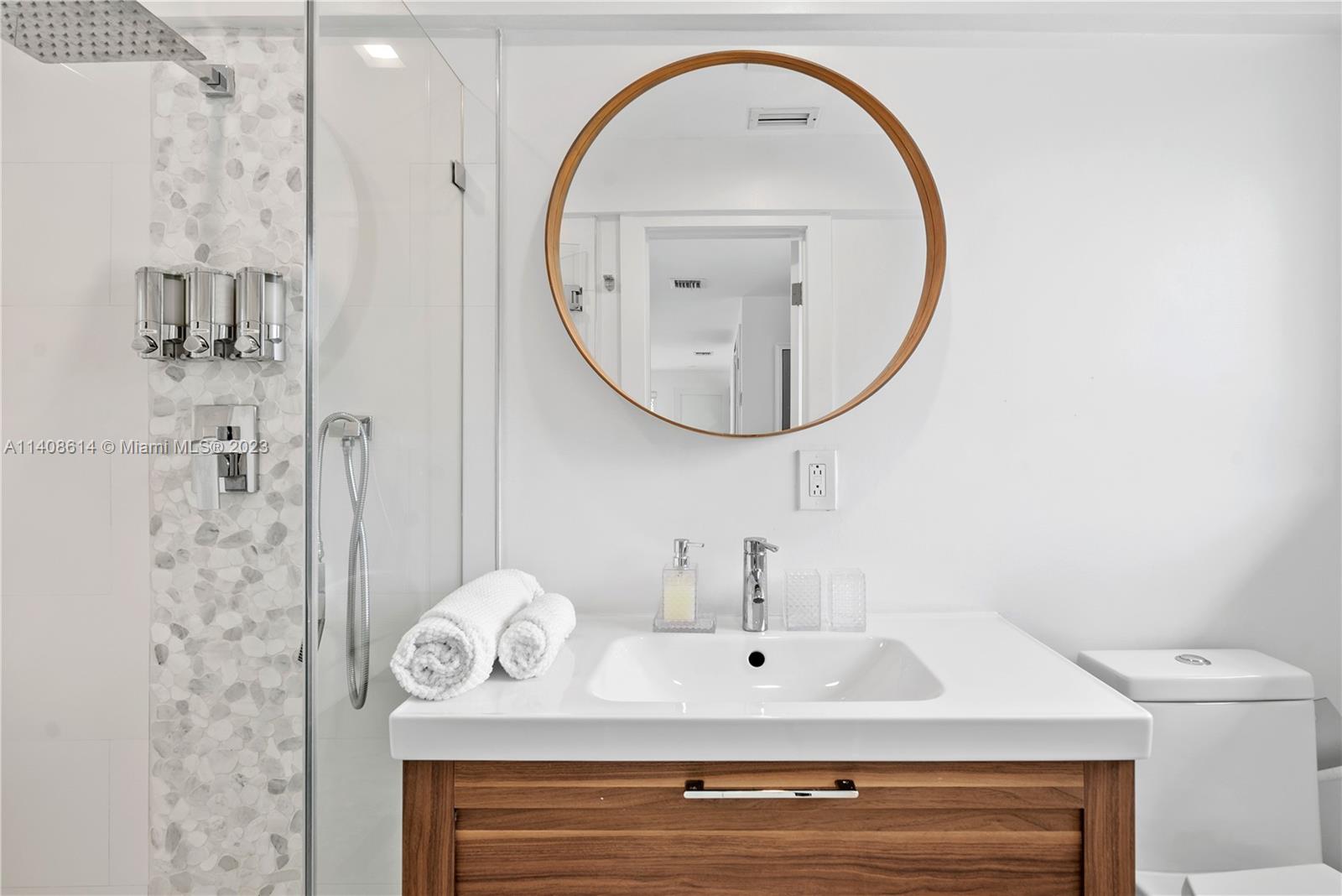 401 Southwest 23rd Road Miami, FL 33129 - Photo 17 of 43 a bathroom with a sink a mirror and a shower