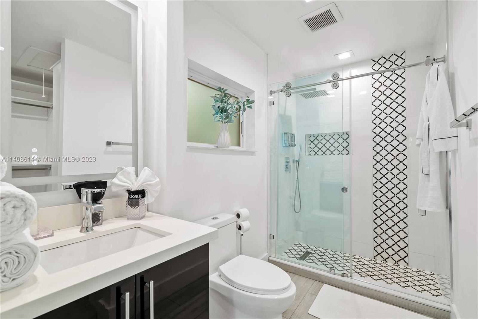 401 Southwest 23rd Road Miami, FL 33129 - Photo 18 of 43 a bathroom with a sink toilet a mirror and shower