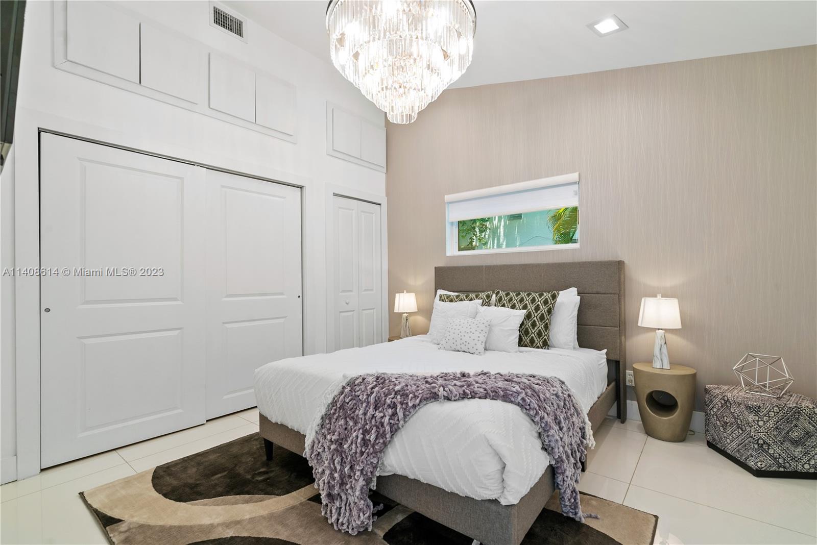 401 Southwest 23rd Road Miami, FL 33129 - Photo 20 of 43 a bedroom with a bed and a window