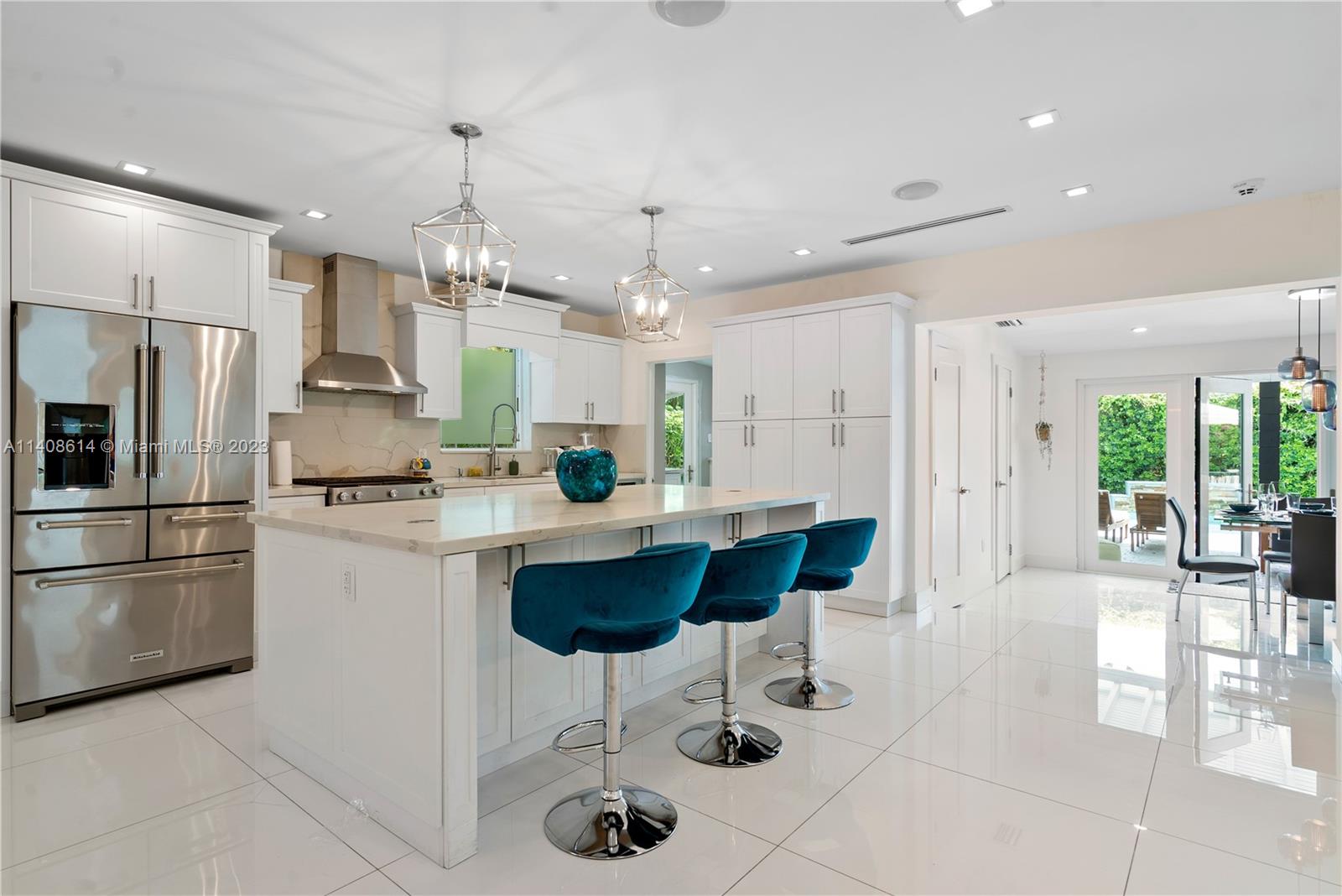 401 Southwest 23rd Road Miami, FL 33129 - Photo 2 of 43 a kitchen with stainless steel appliances kitchen island granite countertop a refrigerator and a sink
