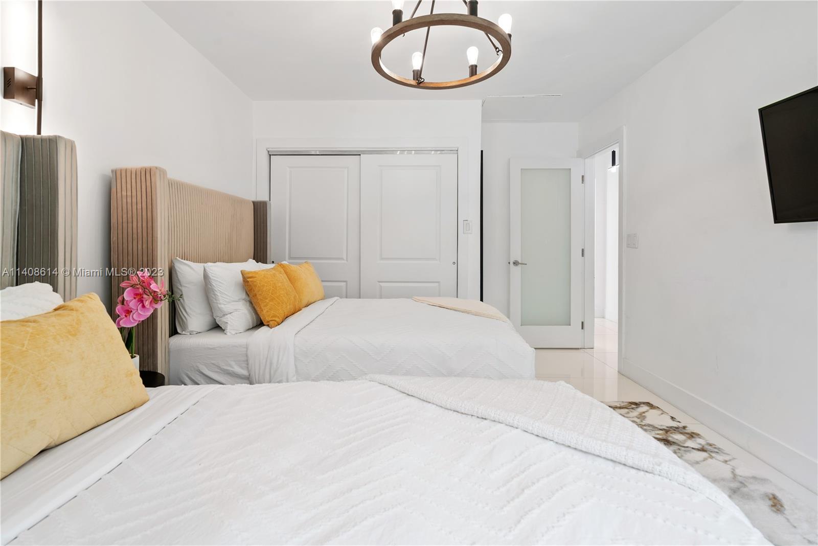 401 Southwest 23rd Road Miami, FL 33129 - Photo 26 of 43 a bedroom with a bed and flat screen tv