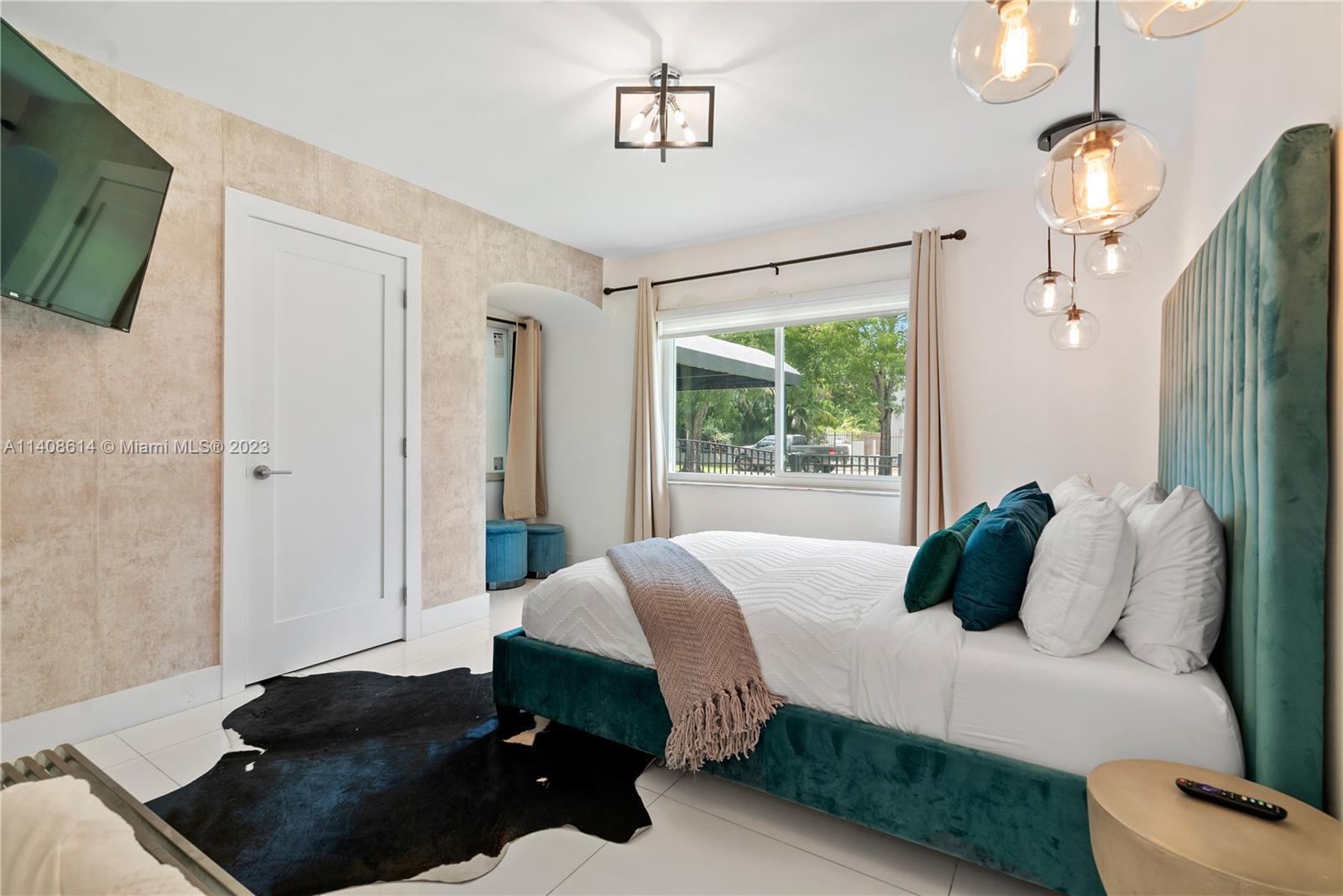 401 Southwest 23rd Road Miami, FL 33129 - Photo 27 of 43 a bedroom with a bed window and a television