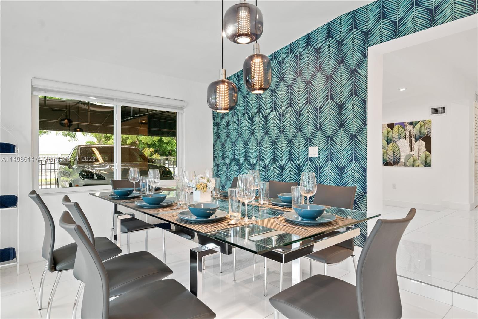 401 Southwest 23rd Road Miami, FL 33129 - Photo 29 of 43 a view of a dining room with furniture wooden floor and a chandelier