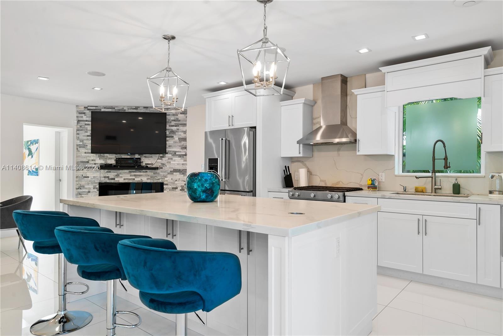 401 Southwest 23rd Road Miami, FL 33129 - Photo 30 of 43 a kitchen with stainless steel appliances a stove a sink a microwave a refrigerator and chairs