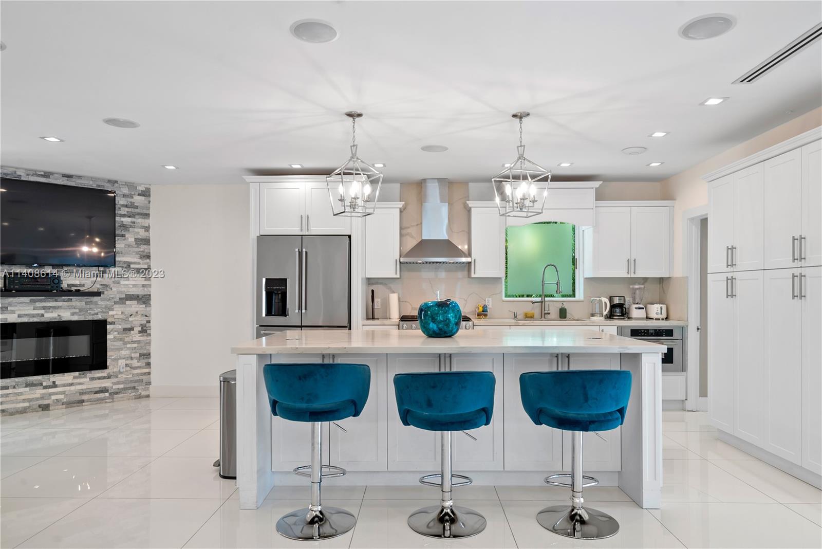 401 Southwest 23rd Road Miami, FL 33129 - Photo 5 of 43 a kitchen with stainless steel appliances a stove a sink a microwave a refrigerator and chairs