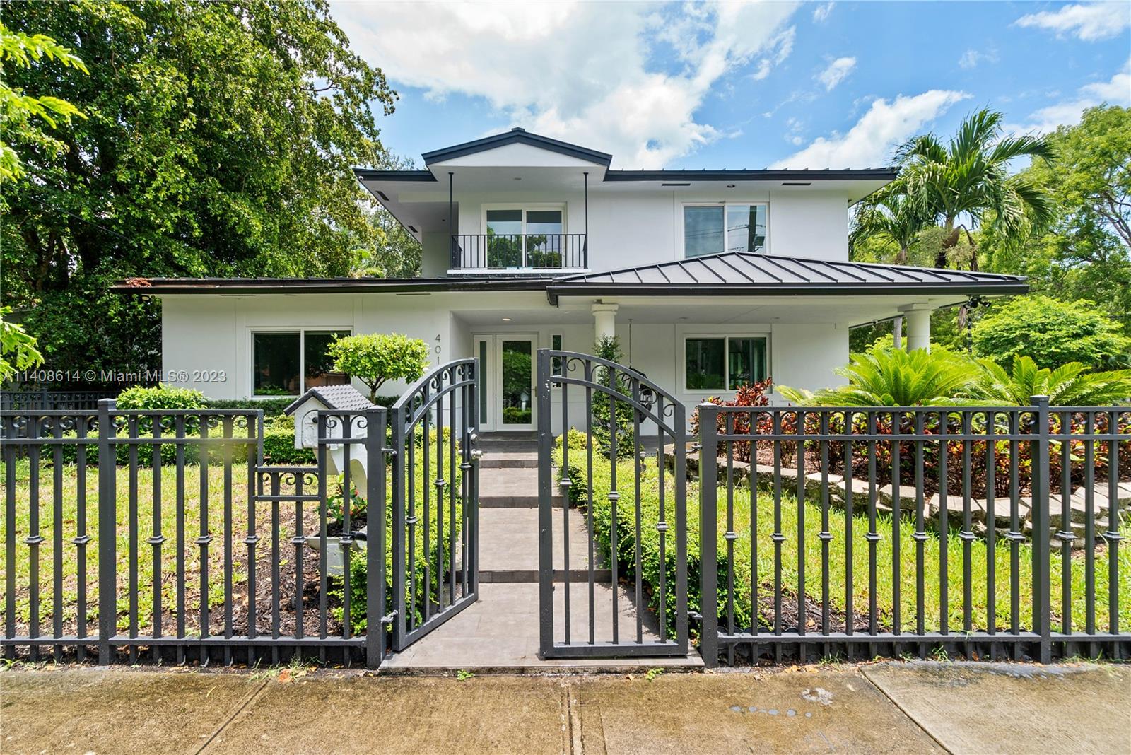 401 Southwest 23rd Road Miami, FL 33129 - Photo 6 of 43 a front view of a house with a garden