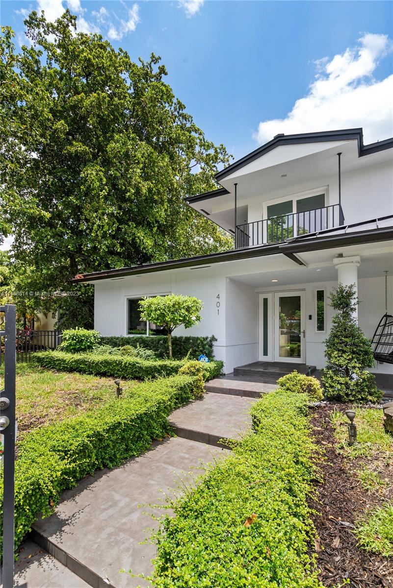401 Southwest 23rd Road Miami, FL 33129 - Photo 8 of 43 a front view of a house with a yard and potted plants