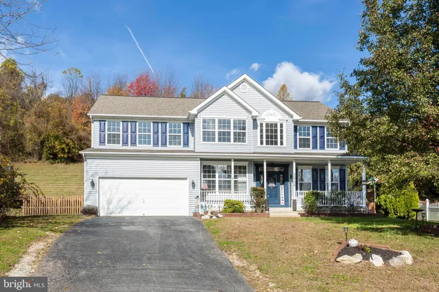 a front view of a house with a garden and yard