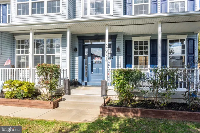 a view of a hallway with a livingroom and furniture