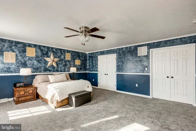 a bedroom with a bed and a night stand