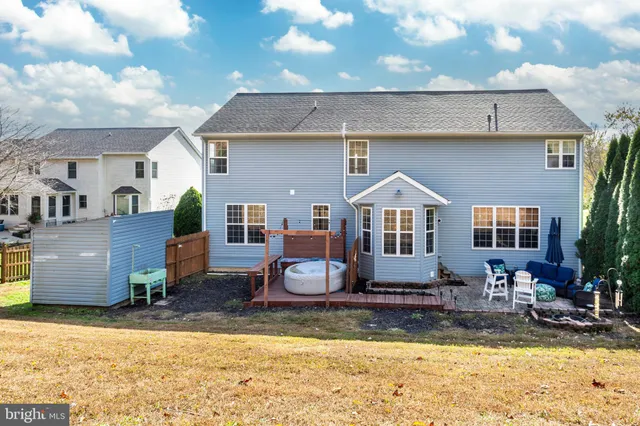 a view of backyard with outdoor seating and plants